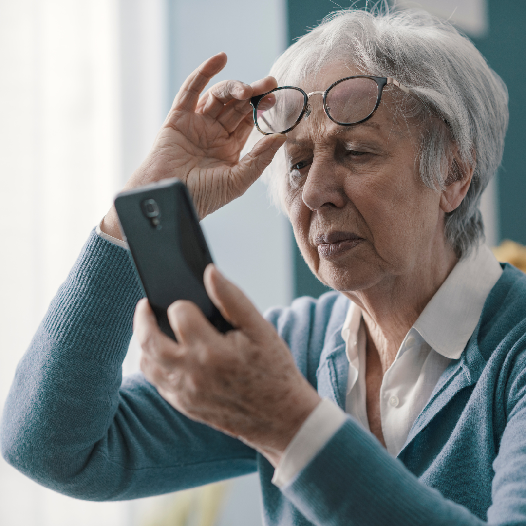 senior woman looking at phone, slightly frustrated